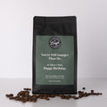 Coffee bag with humorous text that reads 'You're Still Younger Than Me. So There's That. Happy Birthday.' and coffee beans on a white background