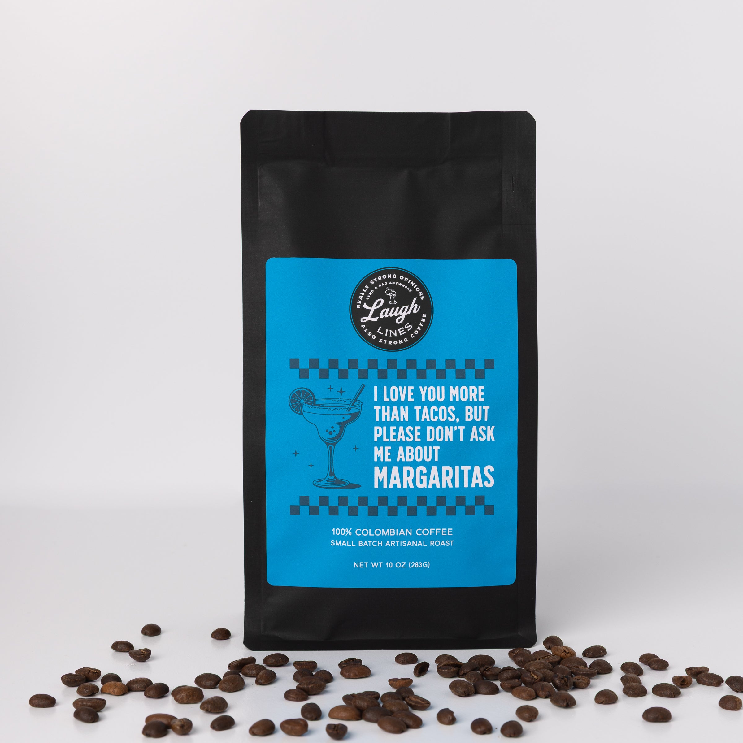 Coffee bag with blue label that reads 'I Love Your More than Tacos, But Please Don't Ask Me About Margaritas' and coffee beans on a white background