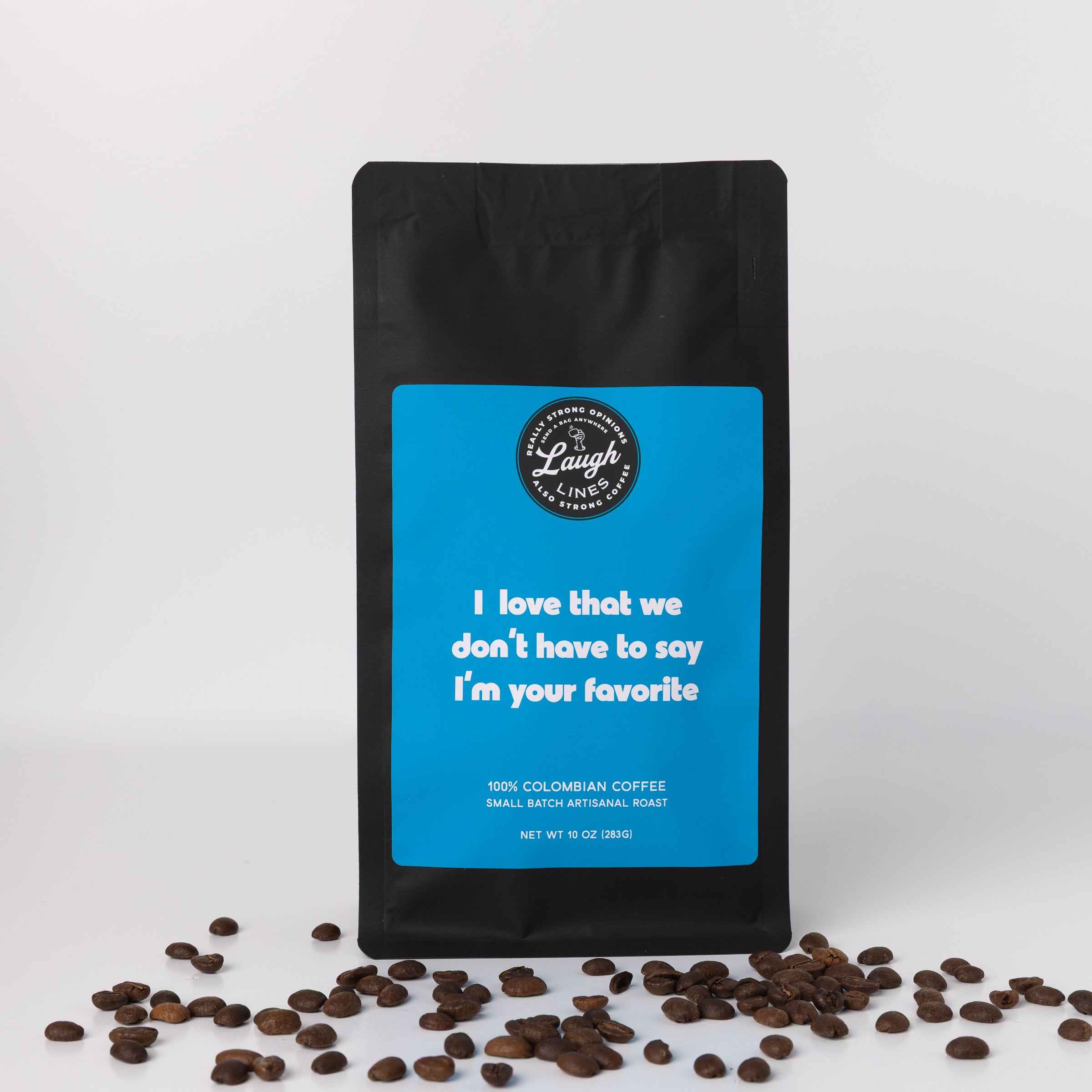 Coffee bag with blue label that reads 'I Love that We Don't Have to Say I'm Your Favorite' and coffee beans on a white background