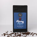 Coffee bag labeled 'Hockey Mom' with coffee beans on a white background