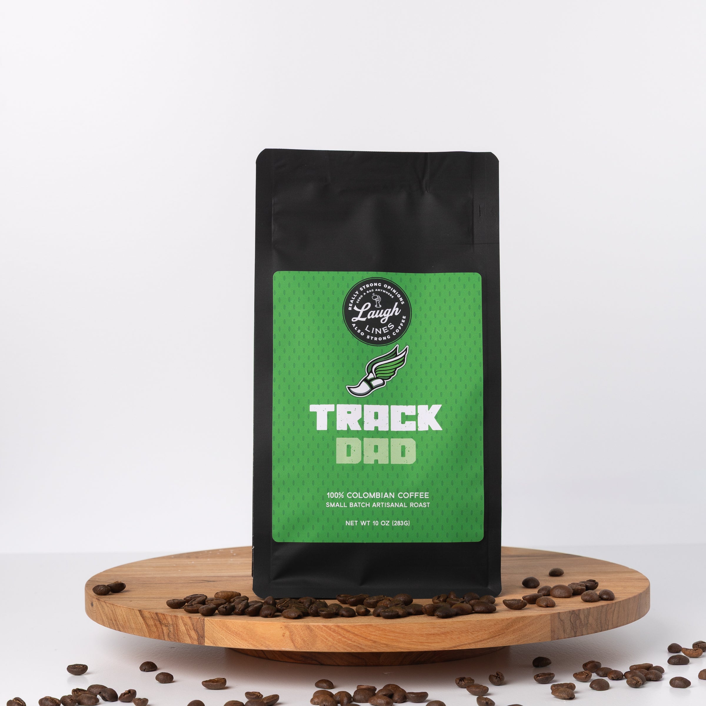 Coffee bag labeled 'Track Dad' with coffee beans on a white background