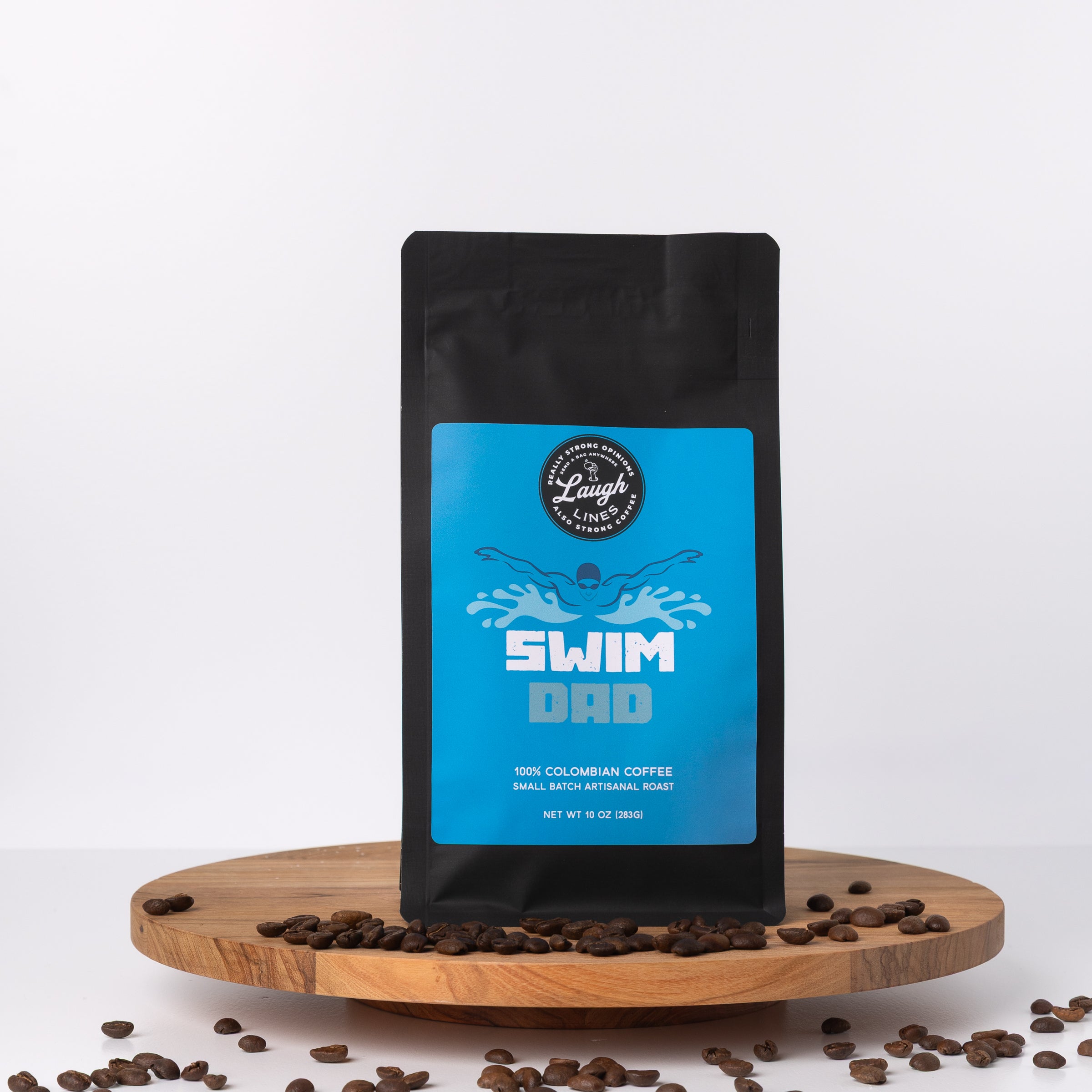 Coffee bag labeled 'Swim Dad' on a wooden platform with scattered coffee beans.