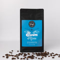 Coffee bag labeled 'Swim Mom' with coffee beans on a white background