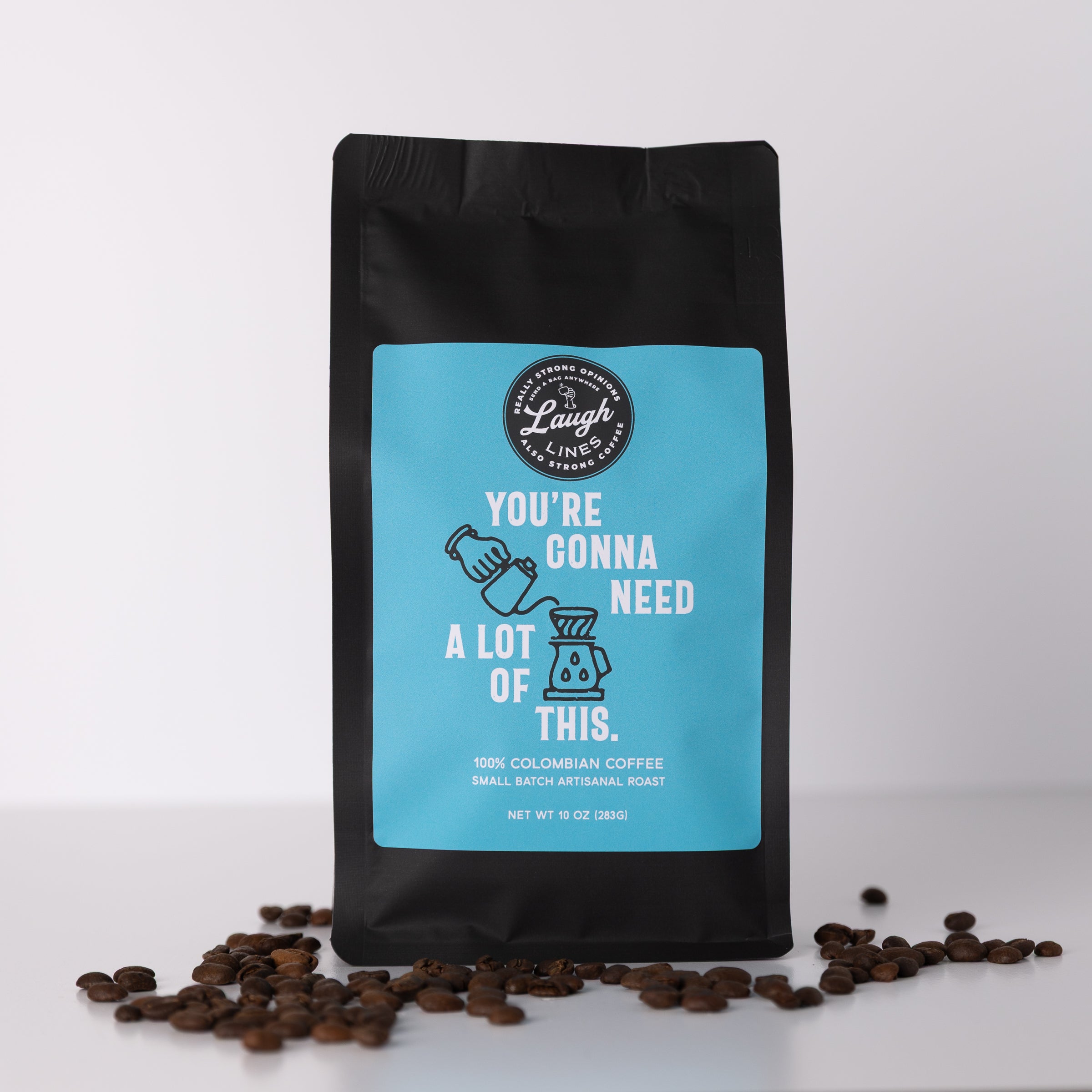 Coffee bag with blue label that reads 'You're Gonna Need a Lot of This' and coffee beans on a white background