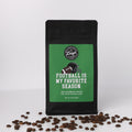 Coffee bag with 'Football is my favorite season' text and coffee beans on a white background