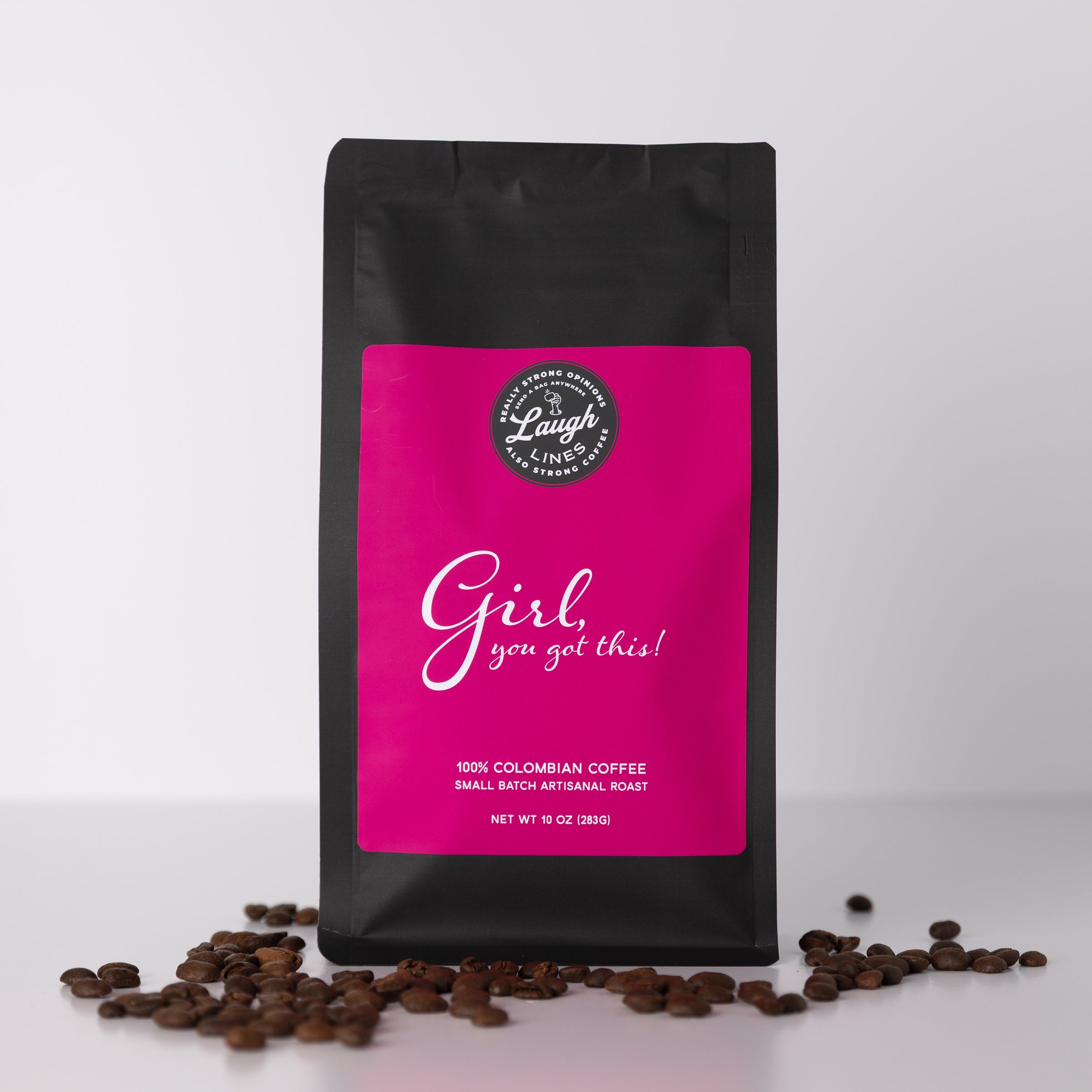 Coffee bag with pink label that reads "Girl, You've Got This!' and coffee beans on a white background
