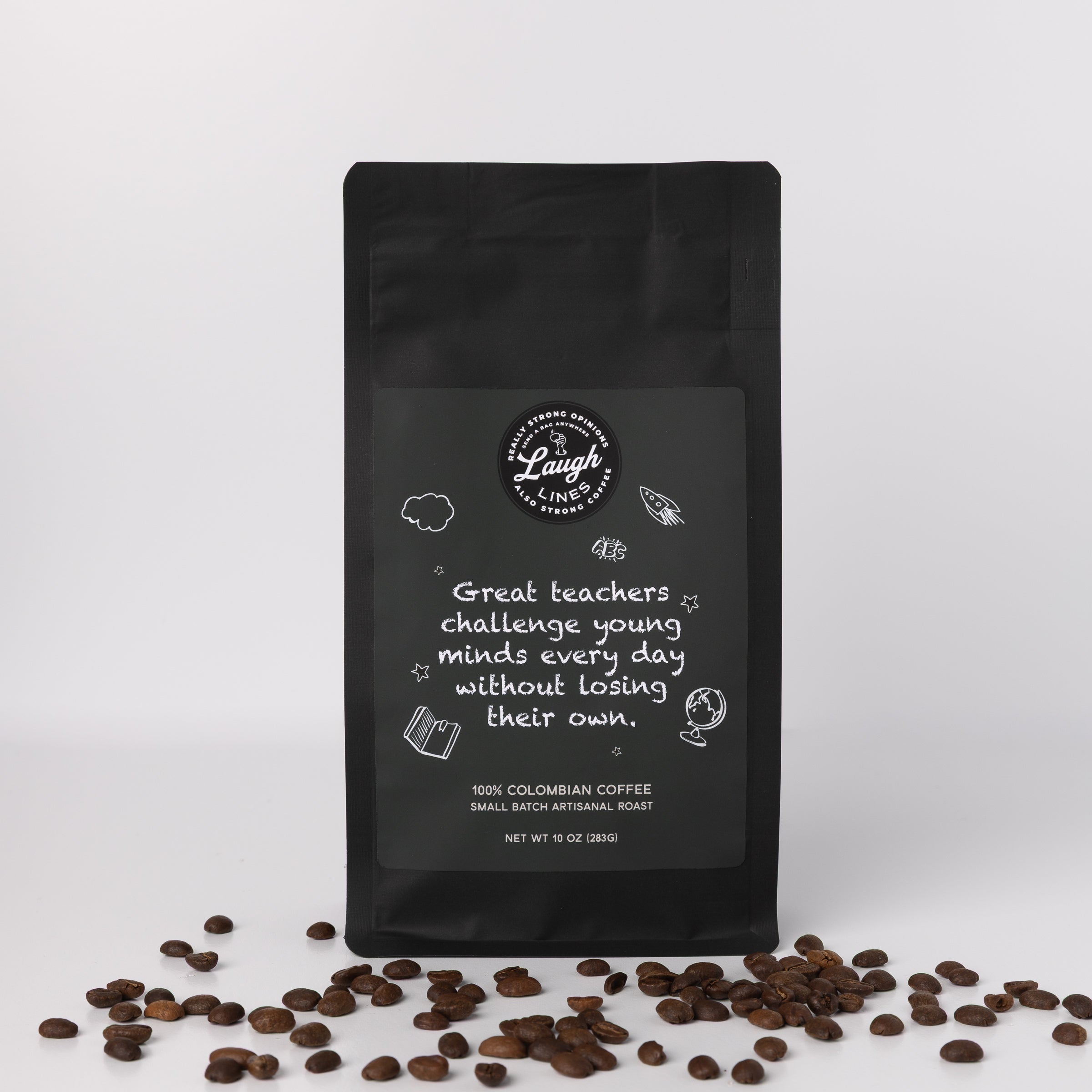 Black coffee bag with text that says 'Great Teachers Challenge Young Minds Every Day without Losing Their Own' and coffee beans on a white background 